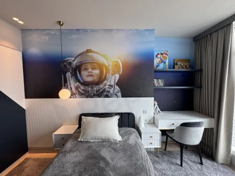 View of a spacious and bright bedroom decorated with modern furniture.