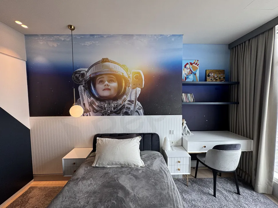 View of a spacious and bright bedroom decorated with modern furniture.
