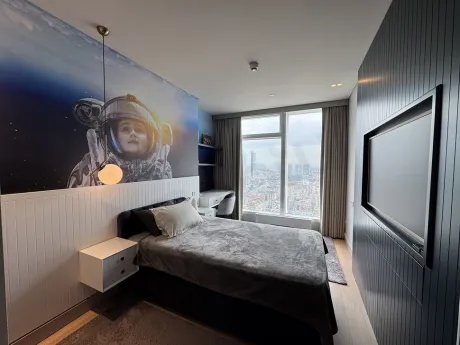 View of a spacious and elegantly furnished bedroom with modern decor.