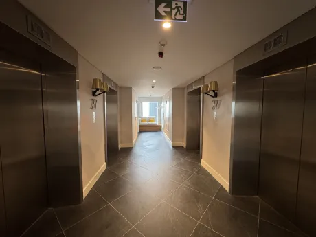 Spacious and bright apartment corridor with modern furniture.