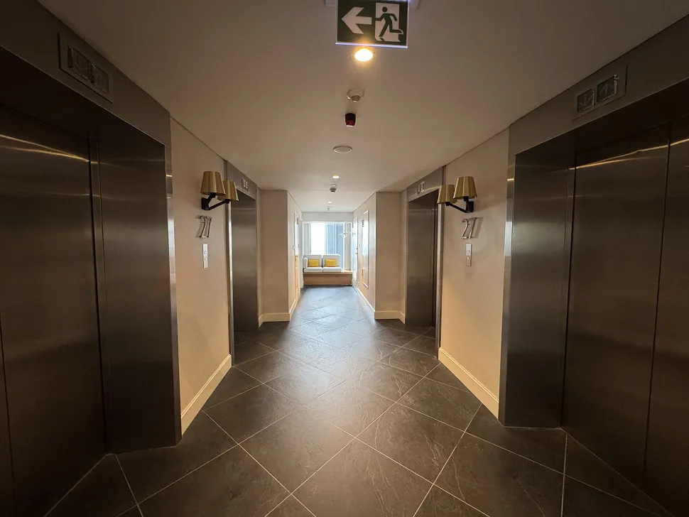 Spacious and bright apartment corridor with modern furniture.