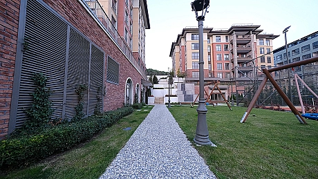 Image of a duplex house with a spacious garden.