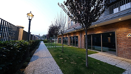 Image of a duplex house with a large garden.