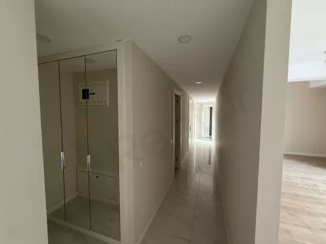 Modernly designed, spacious, and bright interior corridor view of an apartment.