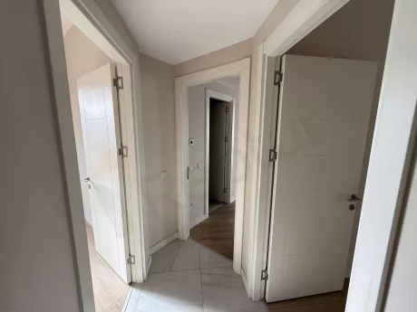 Spacious and brightly lit corridor view of a modern apartment.