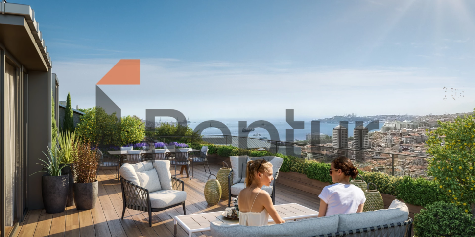 Interior view of a modern 1+1 apartment in Beşiktaş with Istanbul view from wide windows.